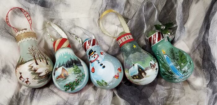 Hand-painted lightbulb Christmas ornaments, displaying creativity turning old junk into something worth keeping.