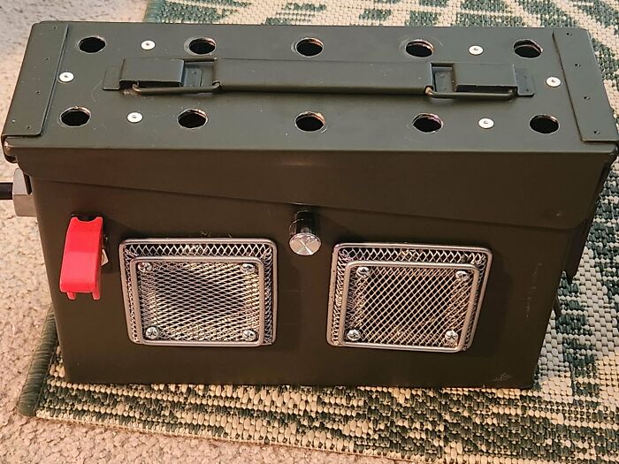 A green military-style box, creatively turned into a speaker system using old junk, demonstrating ingenuity.