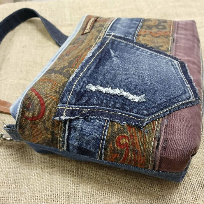 A unique bag made from denim old junk and patterned fabric, showcasing creative repurposing.