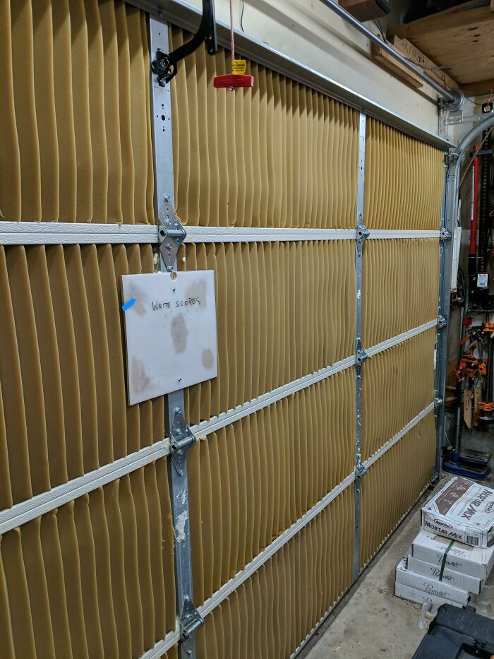 An old junk garage door insulated with cardboard, showcasing creativity in home improvement.