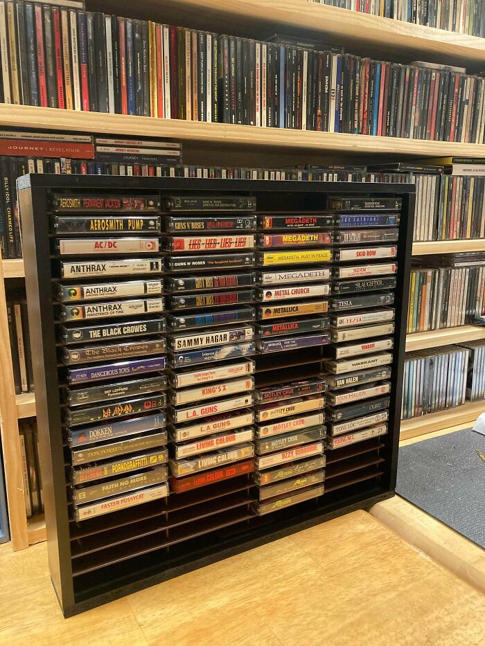A display rack filled with old junk cassette tapes, showing creativity in organizing a music collection.