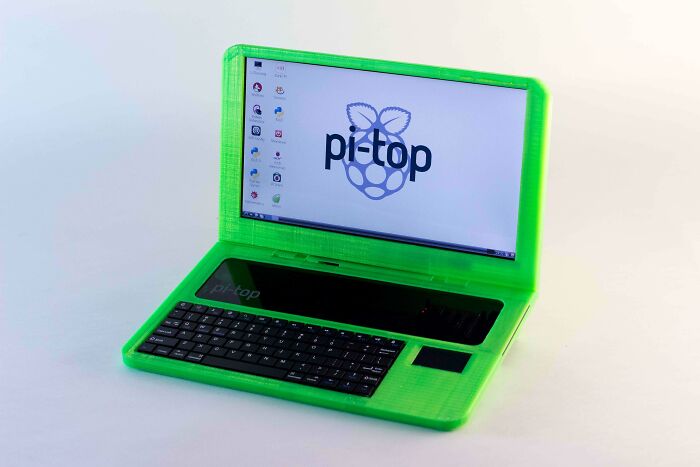 A vibrant green 3D printing laptop with the pi-top logo on the screen, showcasing amazing 3D printing creations.