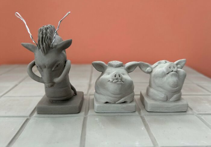 Three small, detailed animal busts made from clay, representing amazing 3D printing creations.