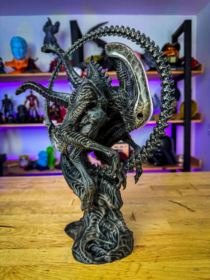 An intricate 3D printing of an Alien Xenomorph statue, surrounded by a skeletal ring, amazing creations.