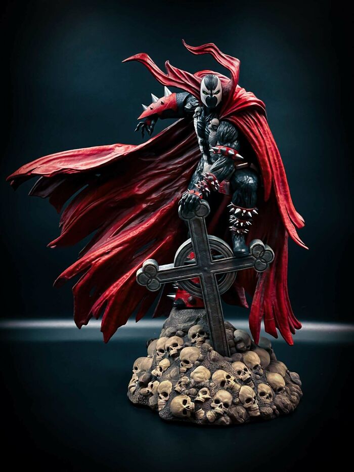 A dramatic 3D printing of Spawn standing on a pile of skulls with a cross, a fan's amazing creation.