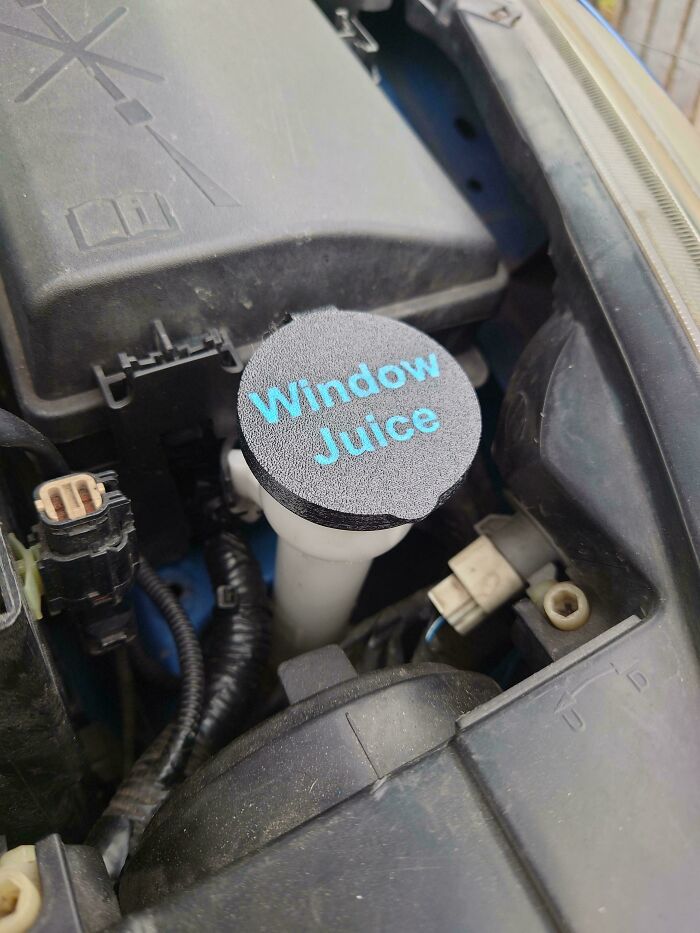 Amazing 3D printing creation: a custom car fluid cap labeled Window Juice on a car engine.