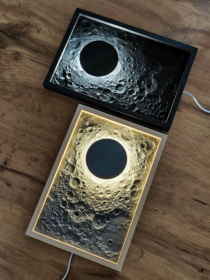 A pair of framed 3D printing moon creations, one with warm light, showcasing amazing creations.