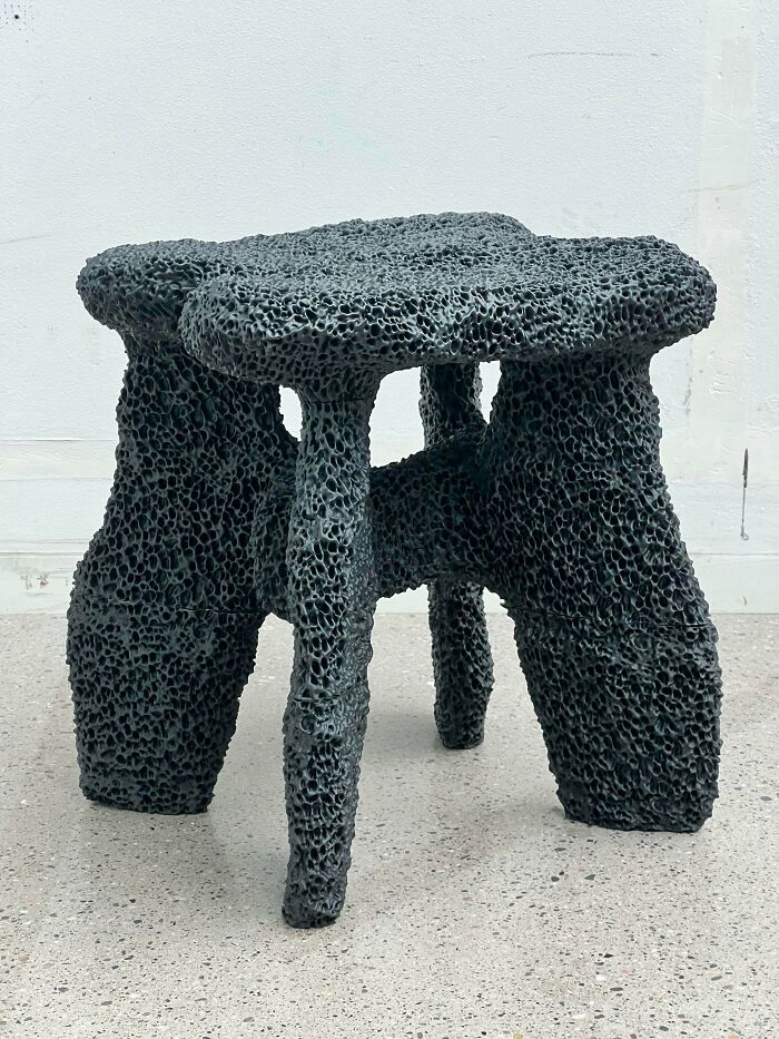 Amazing 3D printing creation of a unique, textured black stool with an organic, porous design.