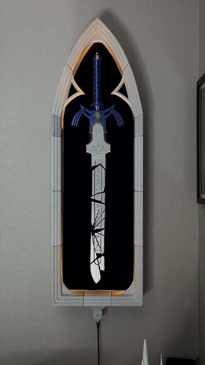 Amazing 3D printing creation of a Master Sword from Zelda in an illuminated wall-mounted display.