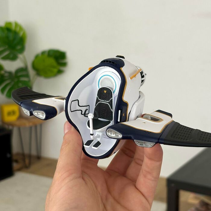 A hand holding a detailed futuristic 3D printing aircraft, one of many amazing creations.