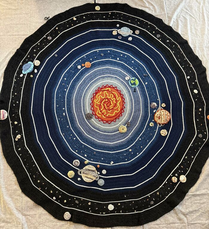 Creative crochet project of a solar system blanket with planets and sun