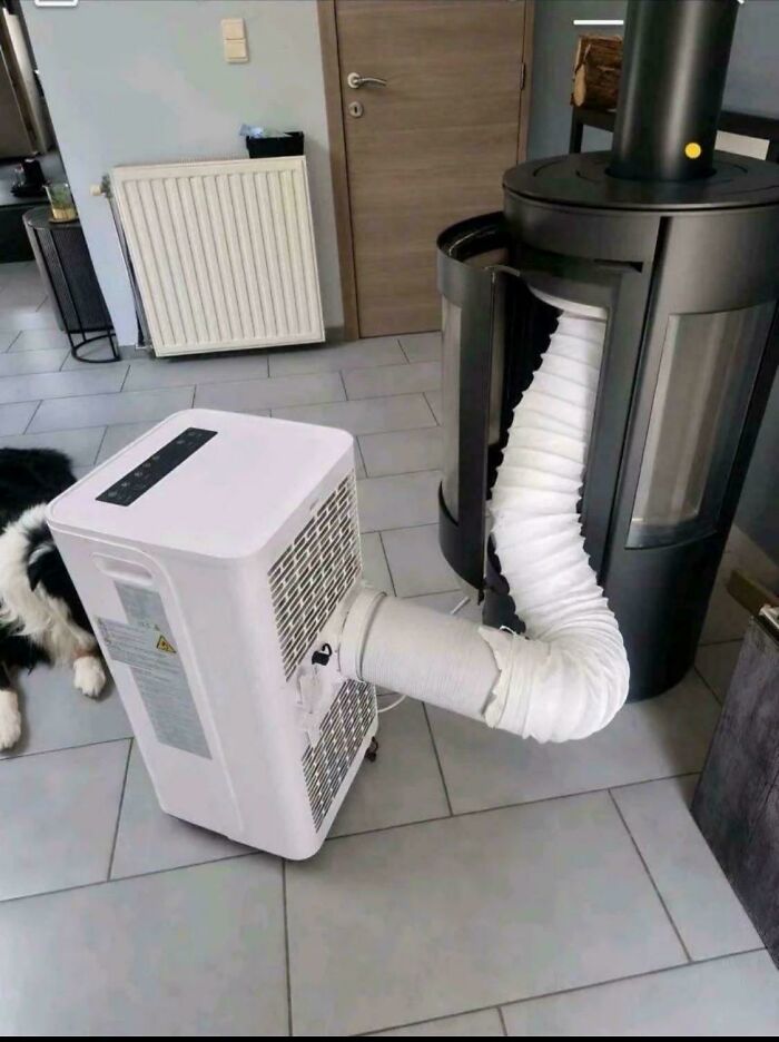A portable air conditioner venting into a fireplace, a clever solution for cooling a room.