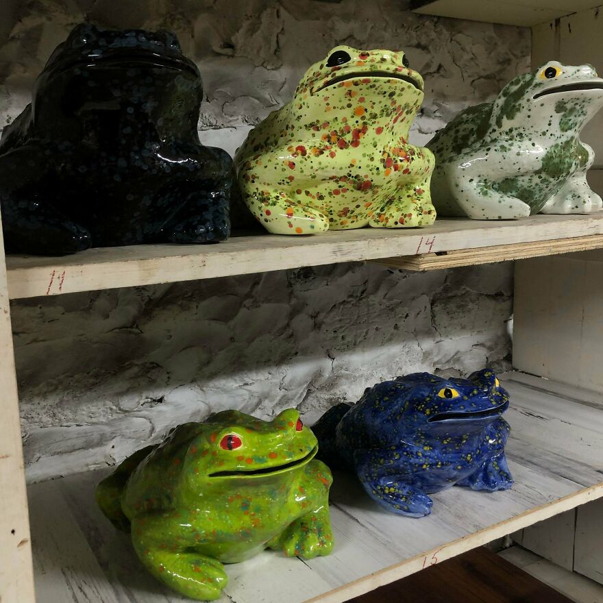 Assortment of whimsical crafts: colorful ceramic frogs on a shelf, showcasing magical artistic creations.