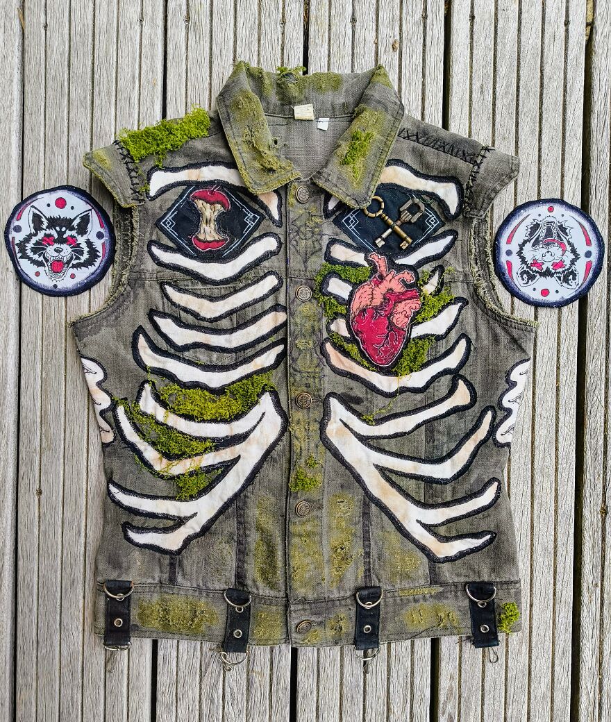 Whimsical crafts: A vest with skeleton and heart patches, embellished with moss for a magical, unique look.