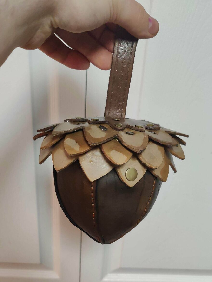 A whimsical craft of a leather acorn-shaped pouch with a leaf-like top, creating a magical accessory.