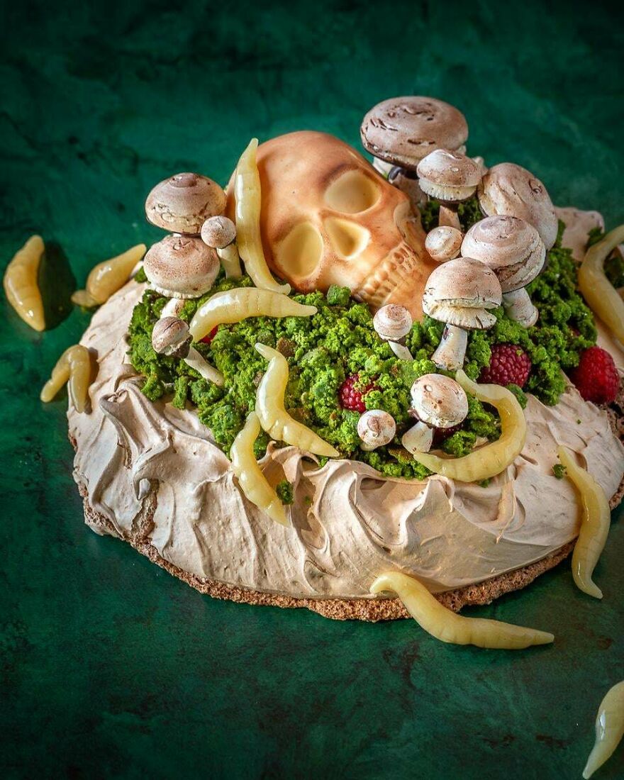 A magical whimsical craft cake adorned with a skull, mushrooms, and green moss, an enchanting online share.
