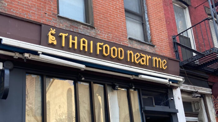 A funny meme of a restaurant sign that simply reads Thai Food near me, sparking laughter.