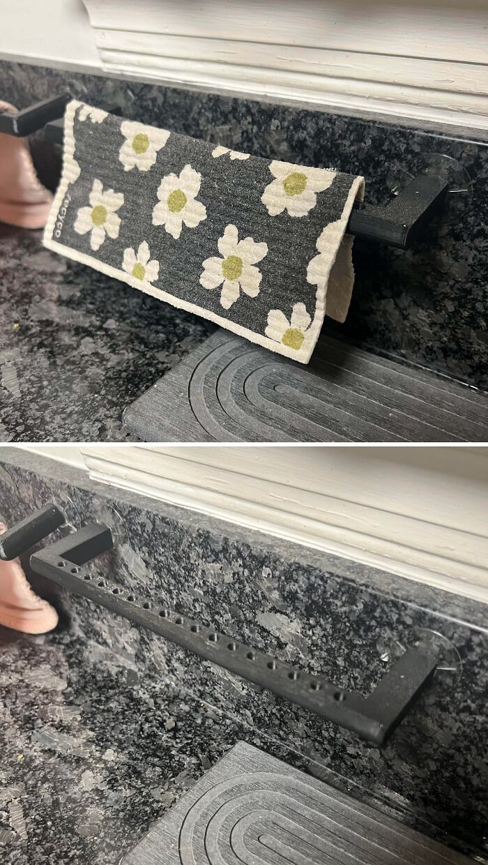 A practical 3D printer project of an under-cabinet towel holder with a floral-patterned cloth hanging from it.