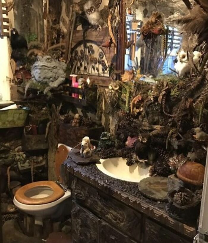 Terribly designed bathroom cluttered with excessive natural decor, creating an overwhelming bathroom environment.