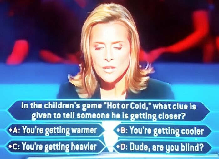 A female contestant on Who Wants To Be A Millionaire with her eyes closed, facing a dumb answer question.