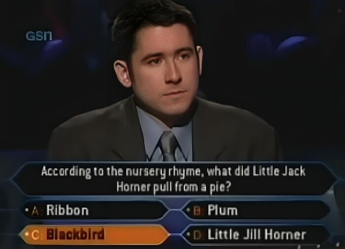 A male contestant on Who Wants To Be A Millionaire, seriously contemplating a dumb answer question.