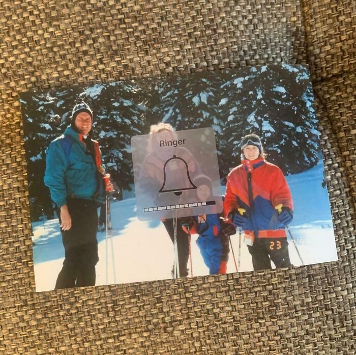 A screenshot of a ringer volume overlay on a physical photo of old people skiing, highlighting their clueless selves online.