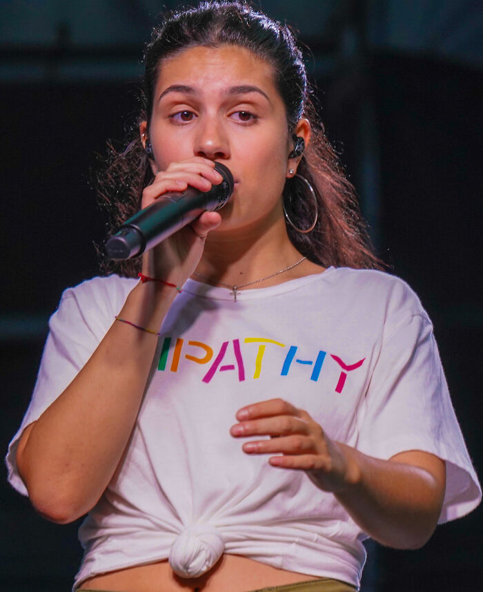 Alessia Cara performing live, showcasing her singing career highlights and musical talent.