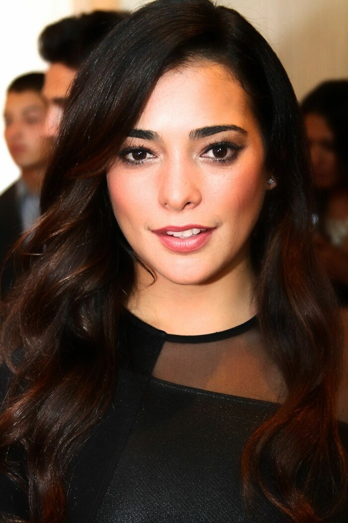 A close-up of Natalie Martinez, highlighting her career with a confident expression and elegant black attire.