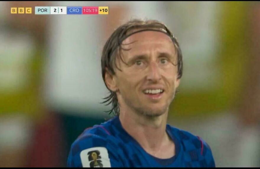 A close-up of a World Cup footballer looking surprised on the field during a game.