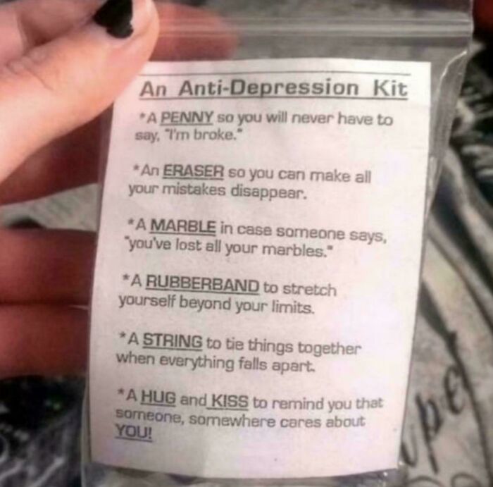 A hand holding a clear bag with an Anti-Depression Kit, a piece of advice showing irony.