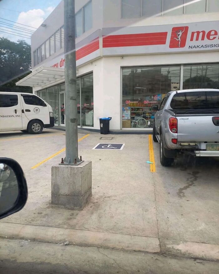 A vehicle parked incorrectly in a handicapped parking spot, showing cultural decline into idiocy.