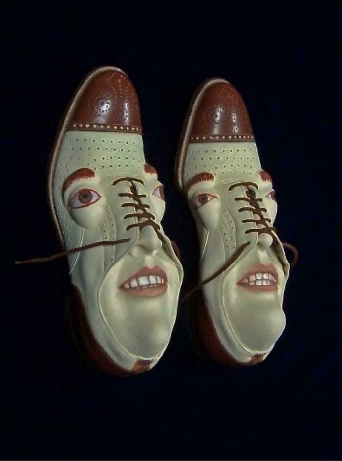 Two brown and white shoes with human-like faces, including eyes and mouths, staring forward, a creepy image for nightmare fuel.