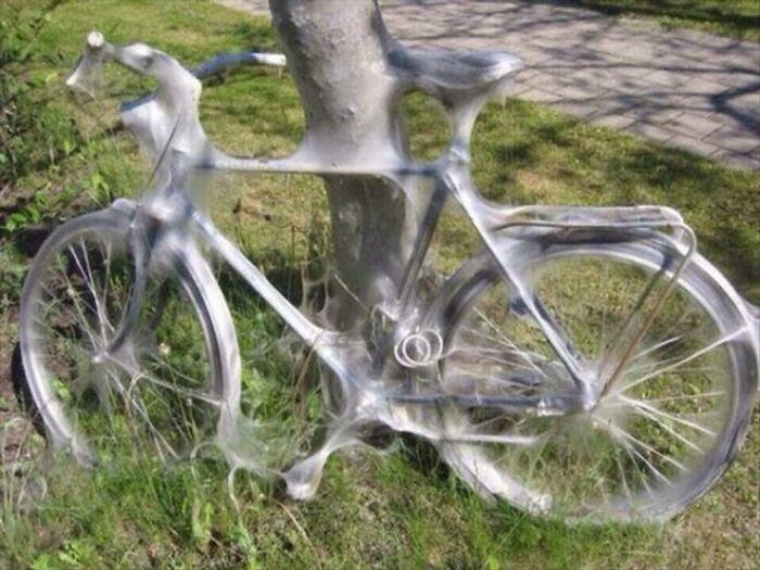 A bicycle completely covered in spider webs, making it a creepy image and nightmare fuel.