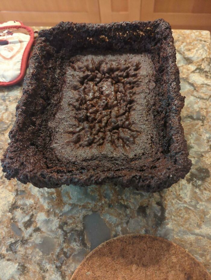 A severely burnt cake or brownie, an example of disgusting food due to being inedible.
