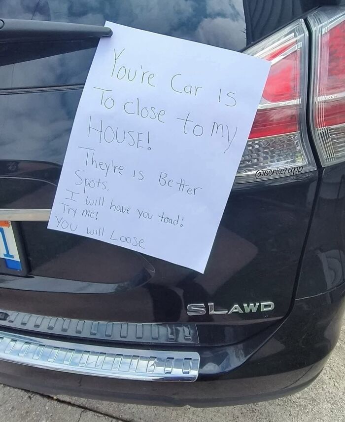 A ridiculous note on a car with misspelled words, illustrating cultural decline into idiocy.