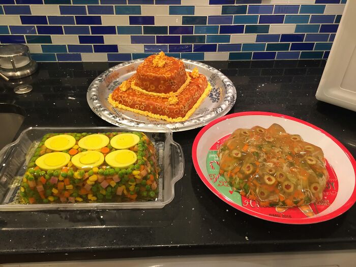 Three different gelatin molds with various ingredients, including eggs and vegetables, appearing as disgusting food creations.