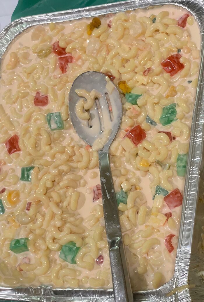 A tray of pasta salad with colorful jelly pieces, an unusual and potentially disgusting food.