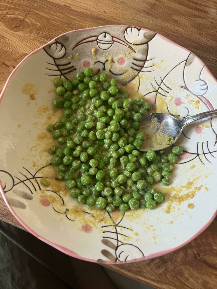 A bowl of green peas with some liquid, showing an example of stupid vegan food.