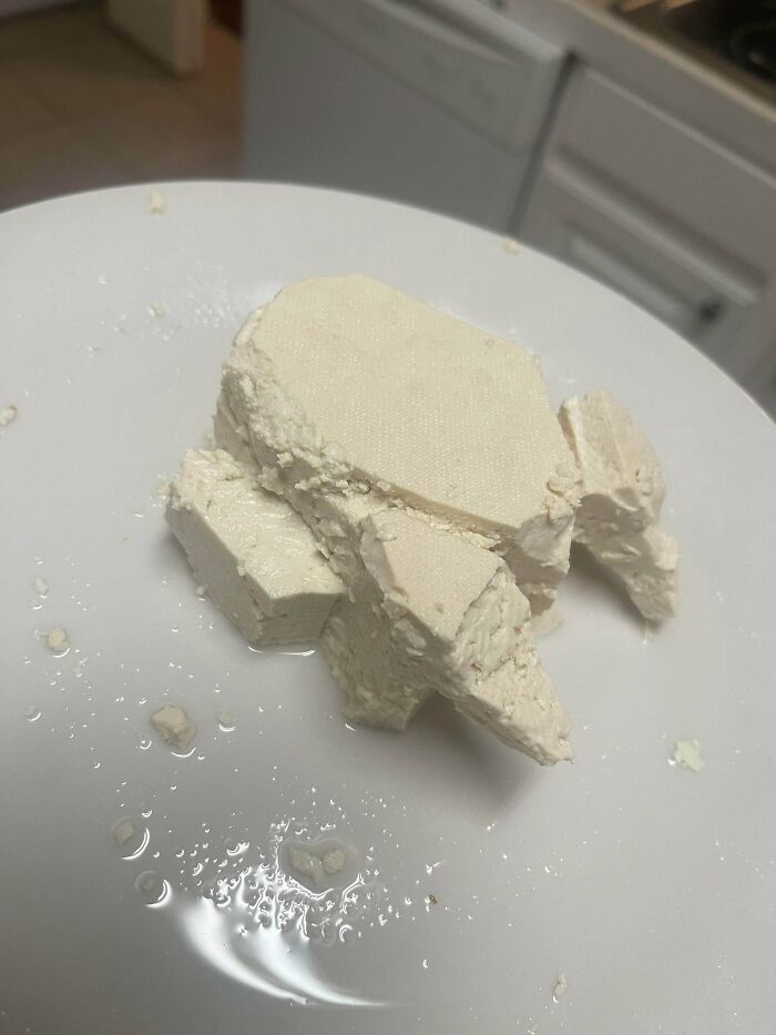 Crumbled blocks of white tofu on a plate, representing stupid vegan food that deserves to be shamed.