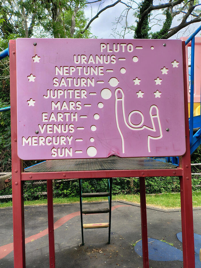 Funny 'You Had One Job' Fails: A playground sign displaying planets in the wrong order with a strange graphic, a funny educational fail.