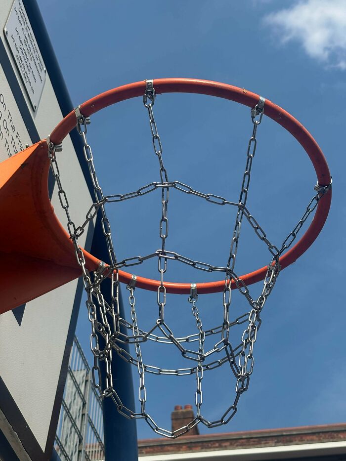 A basketball hoop with a metal chain net, an example of people turning random junk into clever solutions.