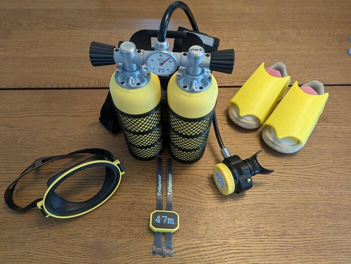 Miniature scuba gear set with yellow tanks, a mask, and flippers, cool things people printed with 3D printers.