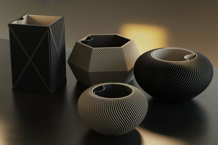 A collection of stylish 3D printed vases and containers in various shapes and textures, showcasing cool and useful 3D prints.