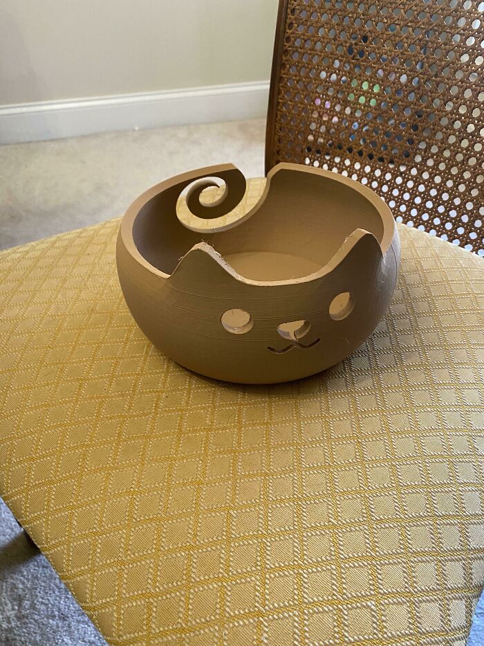 Brown cat-shaped yarn bowl, one of the cool things printed with a 3D printer.