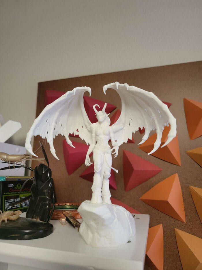 White demon figurine with large wings, a useful thing people printed with their 3D printers.