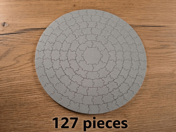 A perfectly round, gray 127-piece puzzle, a cool and useful thing people printed with their 3D printers.