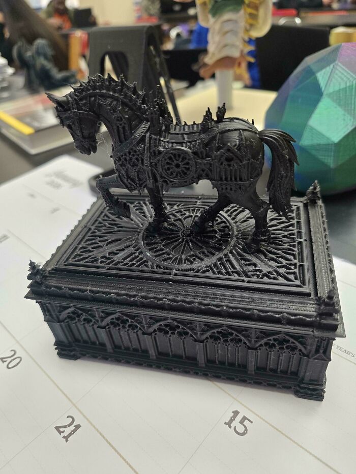 Intricate black horse figurine on a detailed box, one of the cool things printed with a 3D printer.