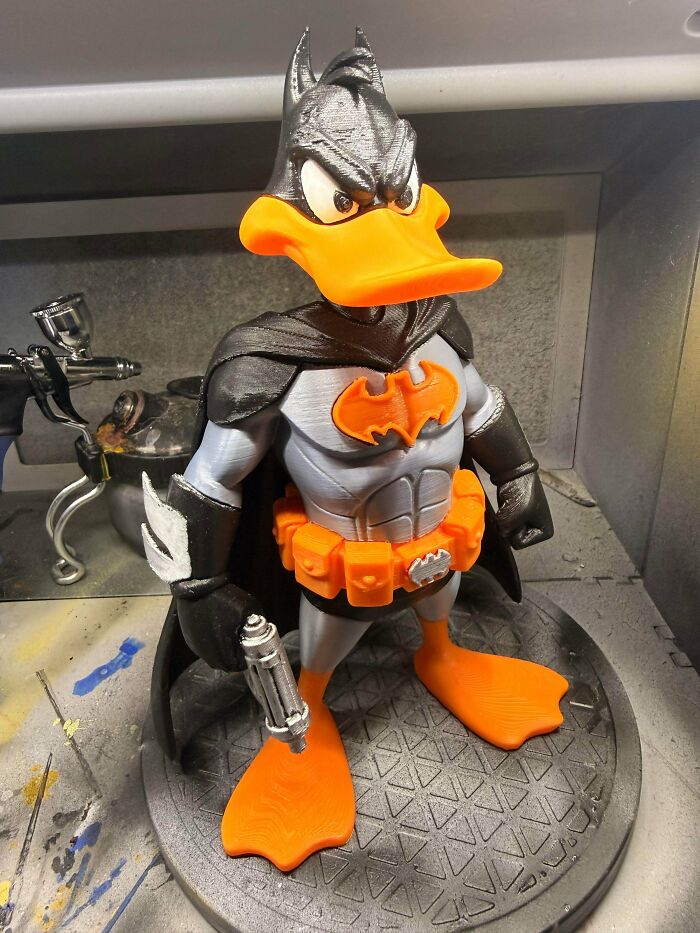 A Daffy Duck figure dressed as Batman with a cape and utility belt, one of the cool and useful things people printed with their 3D printers.