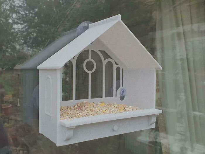 A window-mounted 3D printed bird feeder, one of the cool things people printed with their 3D printers.
