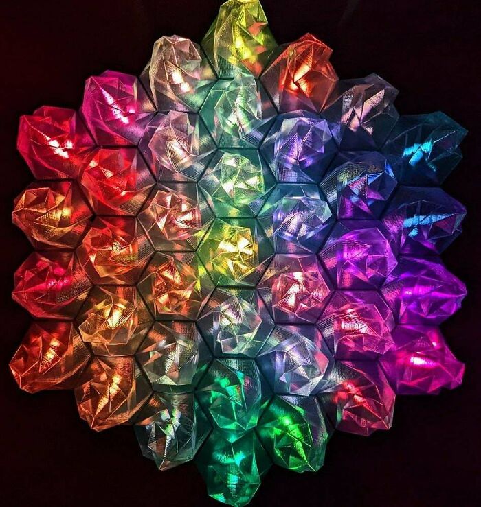A vibrant, colorful array of interconnected hexagonal shapes, showcasing cool and useful things printed with a 3D printer.